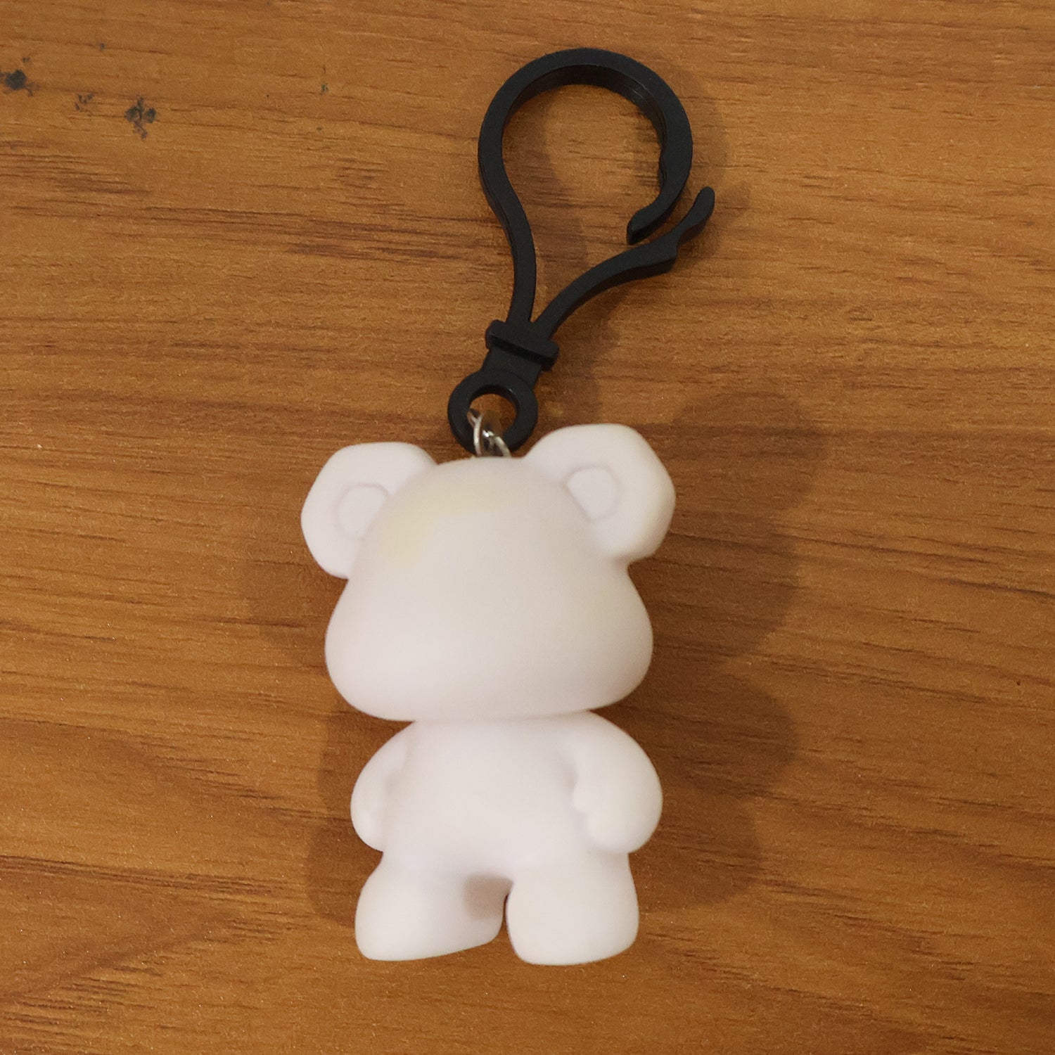 Wukusy cute bear figure keychain featuring a small, plush-style bear with detailed facial features and a keyring attachment.