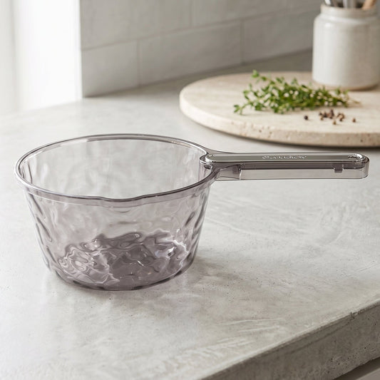 Clear plastic water dipper scoop with handle by Wukusy, suitable for bathroom use, shown with water inside and a handle for easy grip.