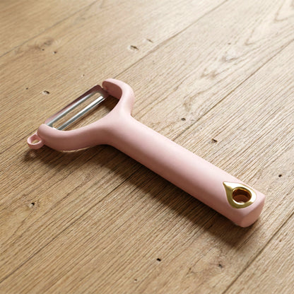 Wukusy handheld vegetable and fruit peeler with ergonomic handle and sharp blade for efficient peeling.