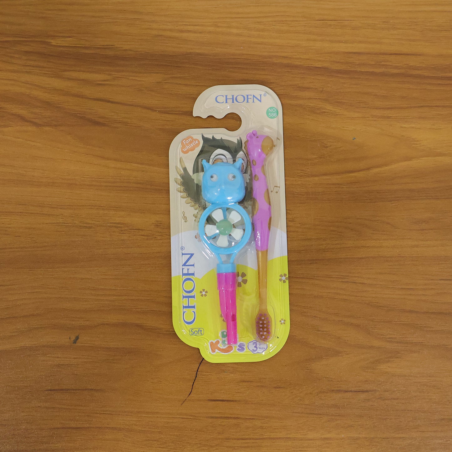 Wukusy kids toothbrush set with two cartoon-themed toothbrushes featuring whistle and fan designs, suitable for children.