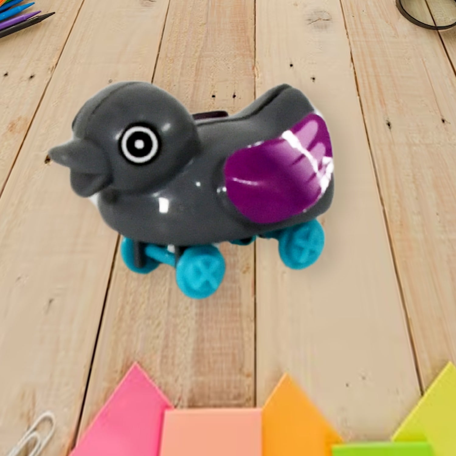 Small Wukusy push-back duck toy with spring tail, colorful DIY duck toy for kids, featuring a cute rubber duck design.