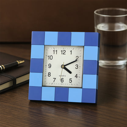 Square quartz table clock by Wukusy showing a sleek, modern design with a white face and black hands on a home decor surface.