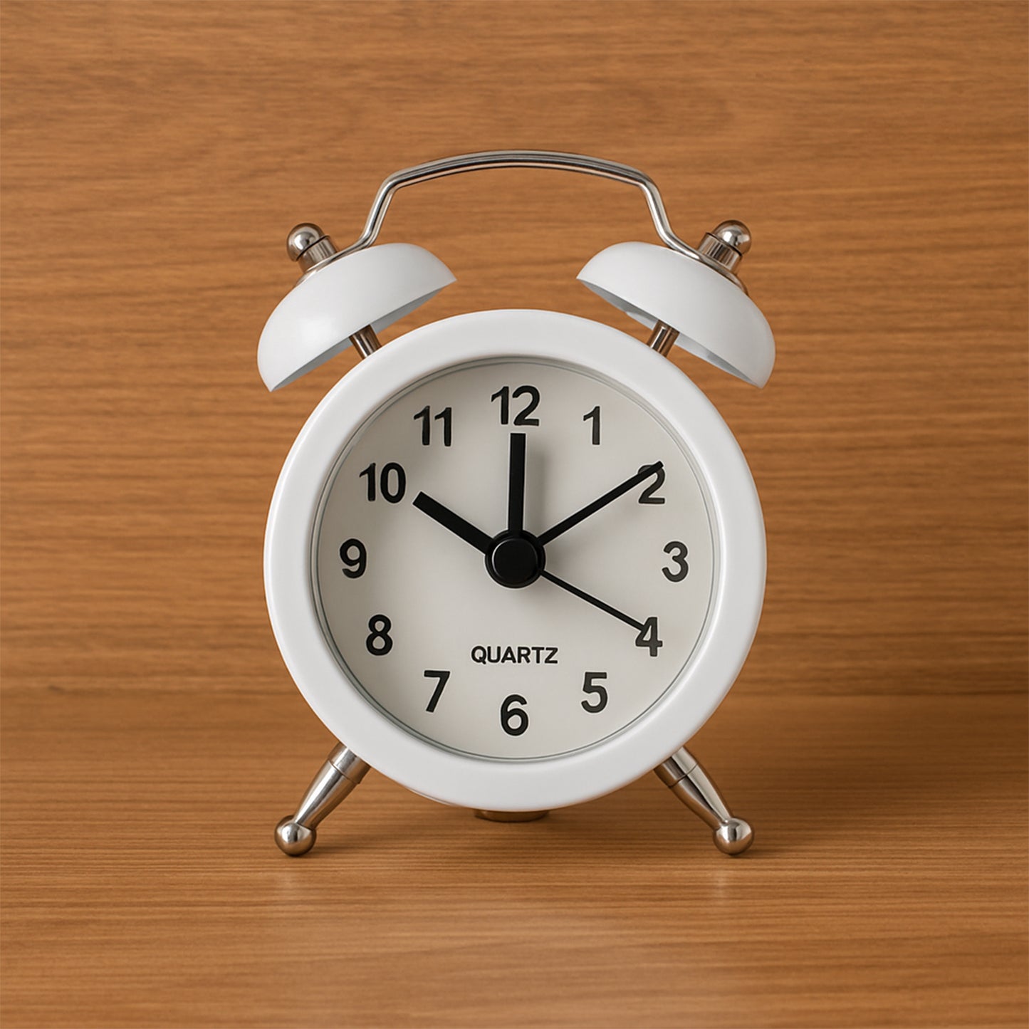 Small Wukusy twin-bell analog alarm clock with classic design, metal bells, and a round white face showing black numbers.