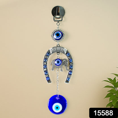 Decorative evil eye wind chime featuring elephant and horseshoe motifs, hanging ornament by Wukusy, crafted with colorful details.
