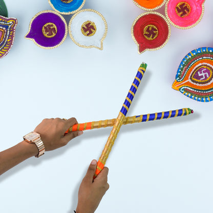 Pair of traditional decorative Dandiya sticks for Navratri Garba by Wukusy, featuring colorful handcrafted designs.