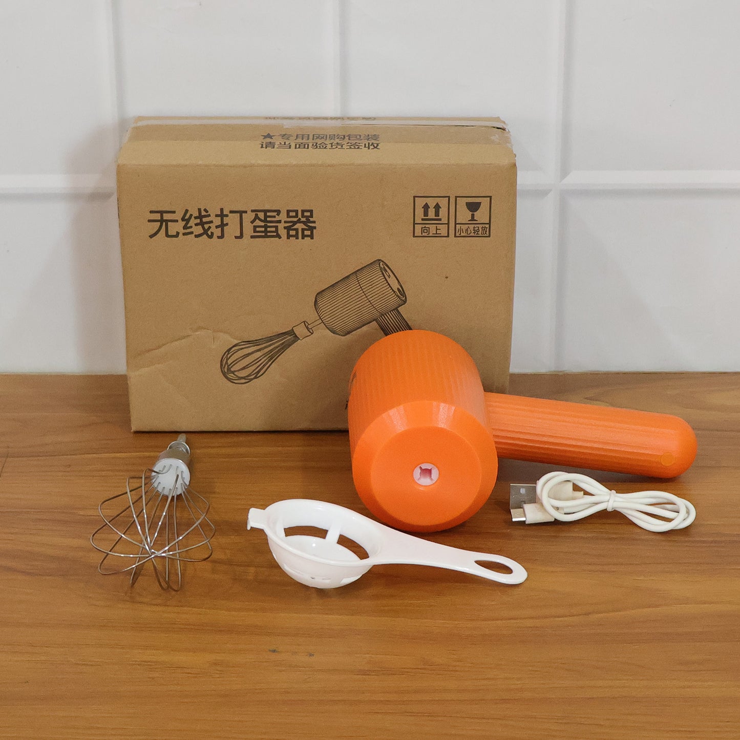 Wukusy portable USB rechargeable electric handheld whisk mixer with blending attachments on a kitchen countertop.