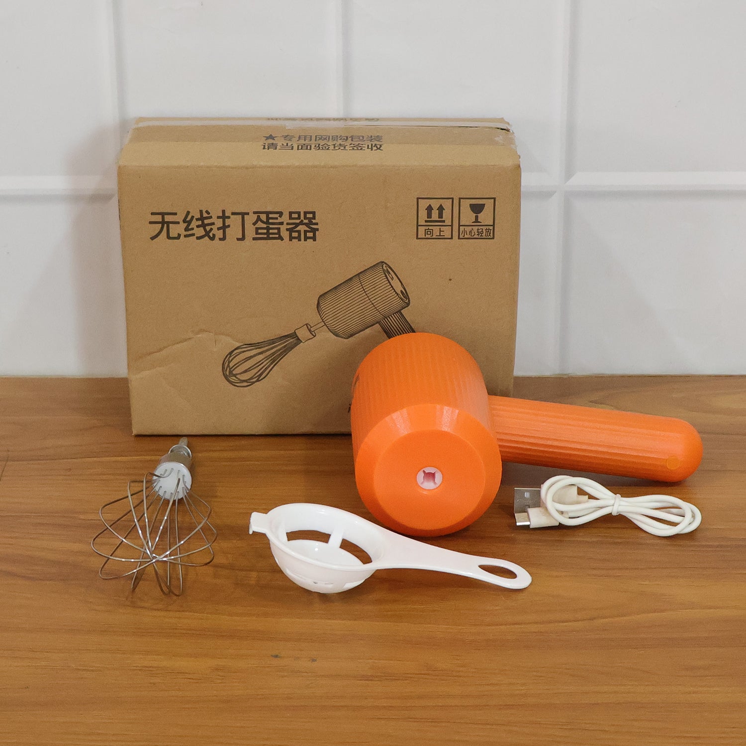 Wukusy portable USB rechargeable electric handheld whisk mixer with blending attachments on a kitchen countertop.