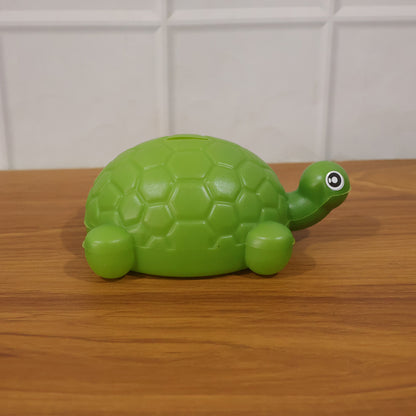 Small tortoise-shaped Wukusy coin money bank for saving coins, with detailed tortoise shell design and secure coin slot.