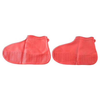 Red waterproof silicone shoe cover by Wukusy, medium size, shown on a pair of shoes to protect from water and dirt.
