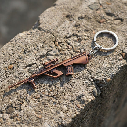 Metal gun-shaped keychain by Wukusy featuring a detailed gun design on a keyring for everyday use