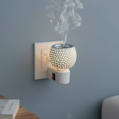 Wukusy premium plug-in star cut glass aroma diffuser night lamp with illuminated star design and sleek glass finish.
