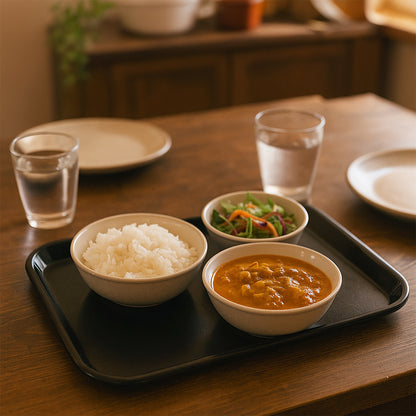 Black plastic serving tray plate from Wukusy, 40x30 cm, showcasing a smooth surface and sturdy design for serving food.