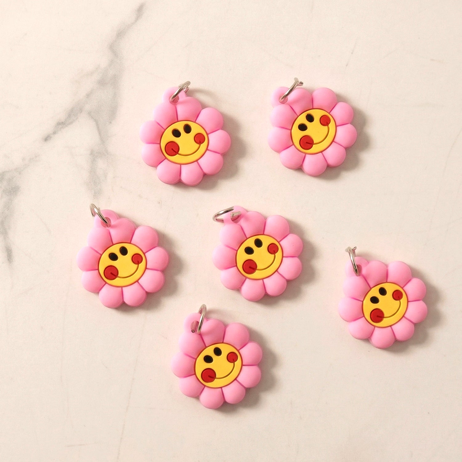 Set of 10 Wukusy smiley flower shape bag charm keychains with bright colors and cheerful designs.