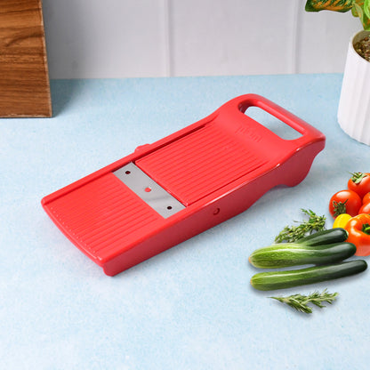 Wukusy Supermom Easy Plus vegetable slicer on kitchen countertop, showing multiple slicing blades for efficient vegetable preparation.