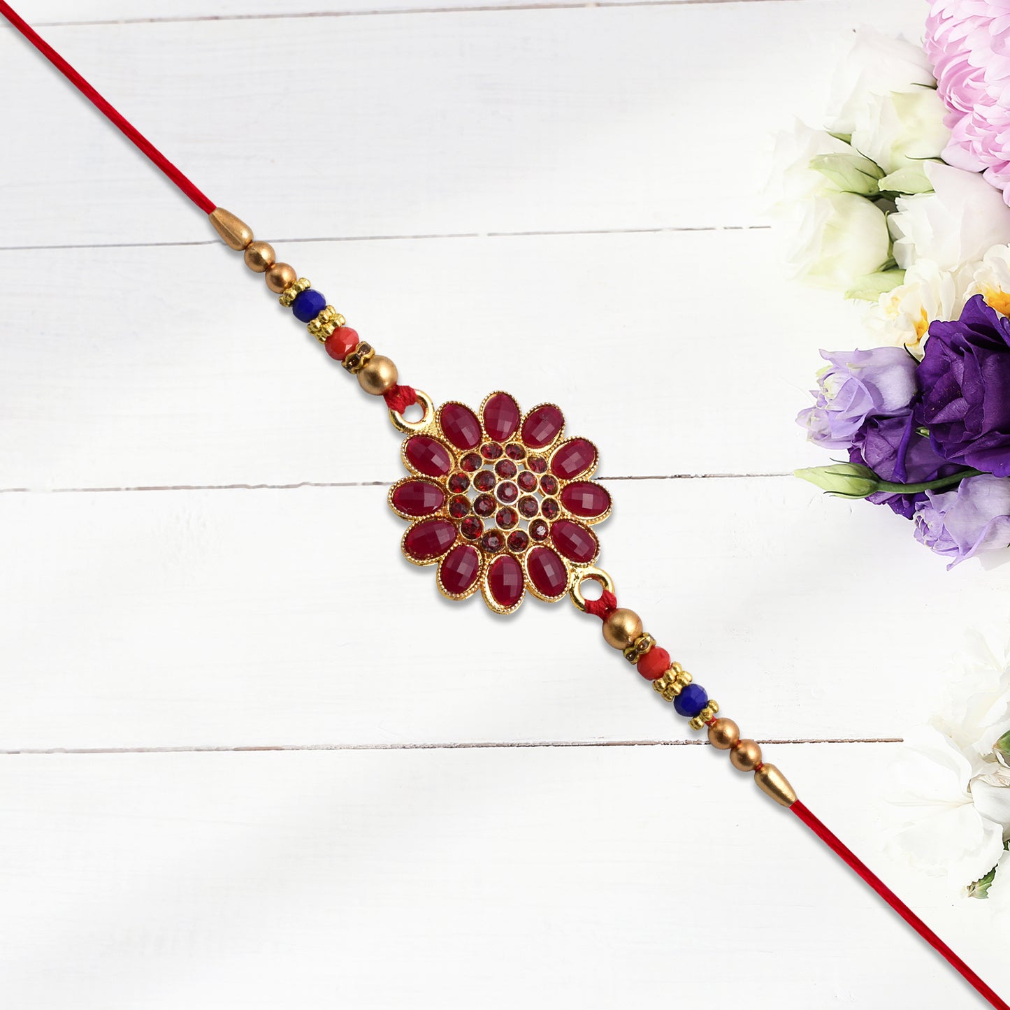 Red floral stone rakhi with bead accents, Wukusy fashion bracelet featuring vibrant floral design and decorative beads.