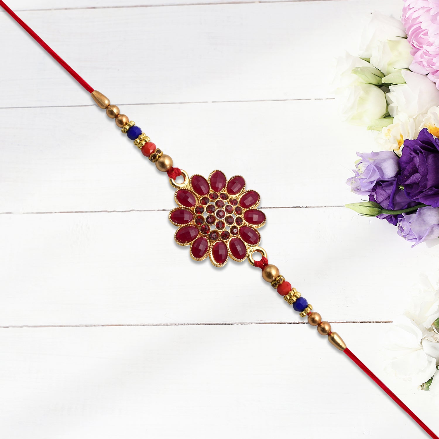 Red floral stone rakhi with bead accents, Wukusy fashion bracelet featuring vibrant floral design and decorative beads.