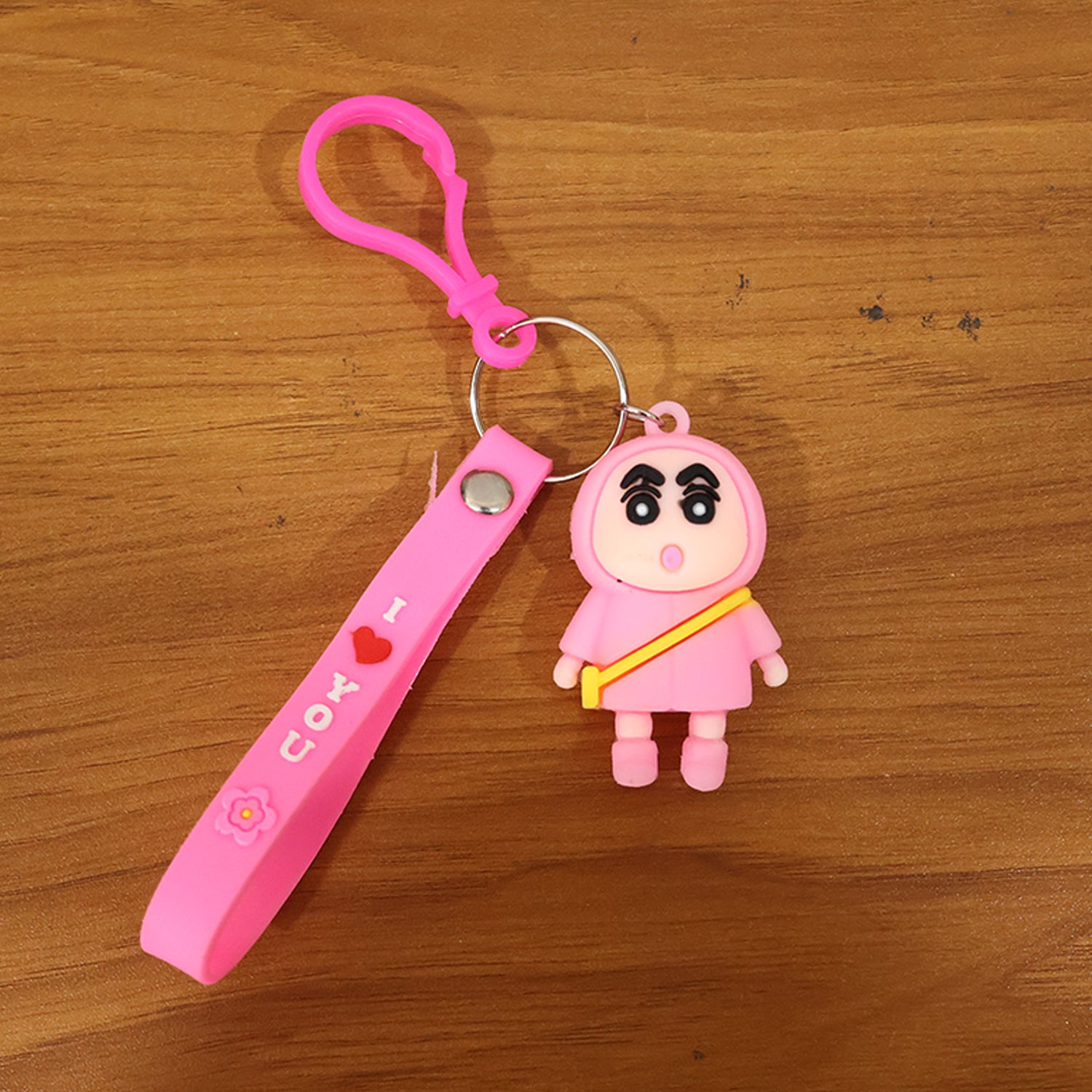Cute cartoon doll figure keychain by Wukusy featuring a colorful, playful design with a smiling character and a metal keyring.