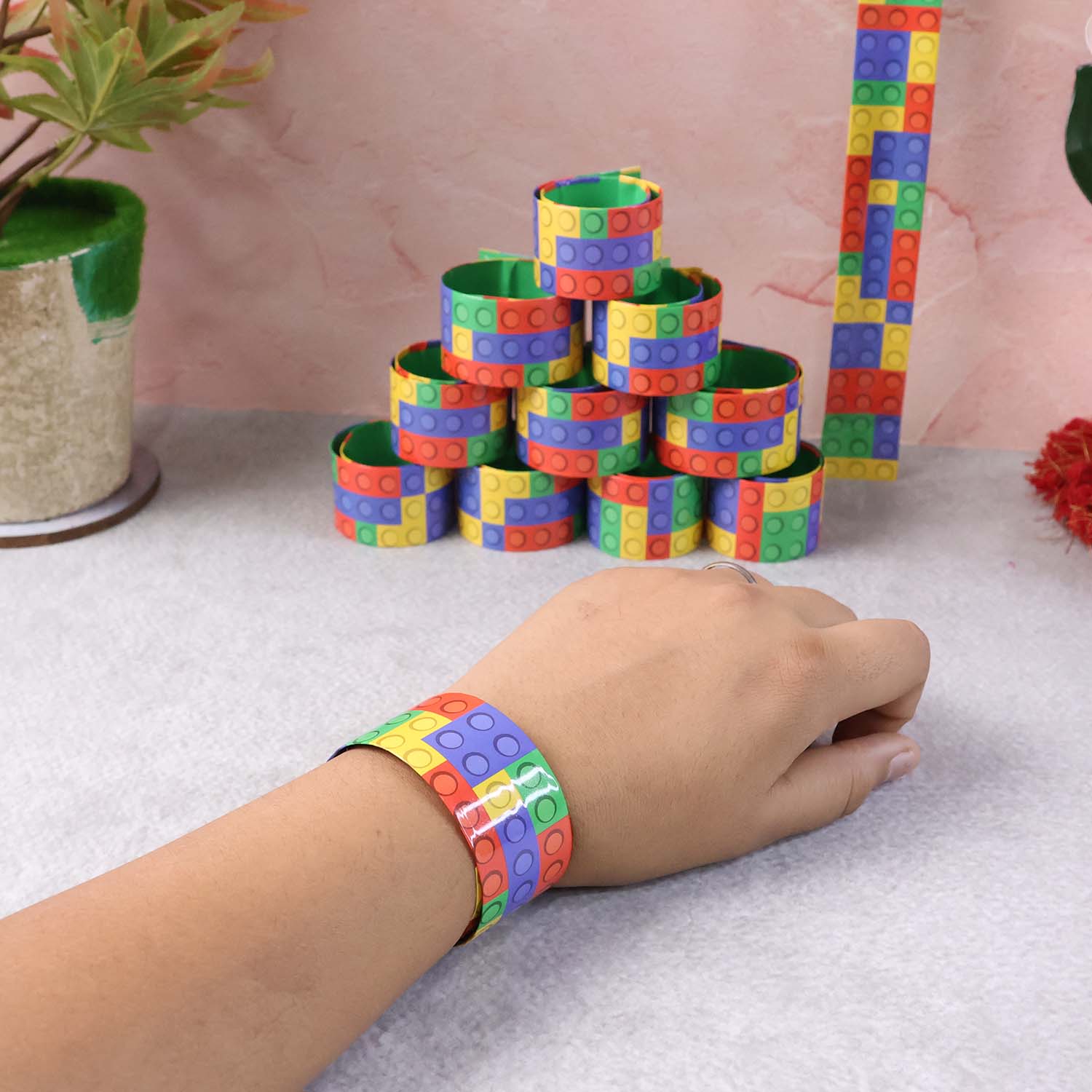 Colorful Snap Slap Bracelet Toy set by Wukusy, featuring 12 vibrant flexible bracelets for kids' play and fun.