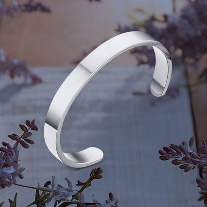 Silver-tone stainless steel open-ended kada bracelet by Wukusy, minimalist polished design for fashion wear.