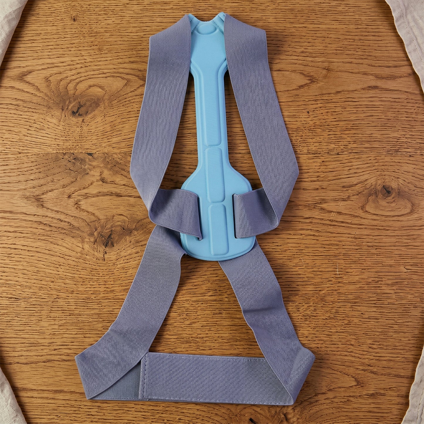 Wukusy ergonomic adjustable back posture corrector support belt in medium size, worn around the shoulders and back for support