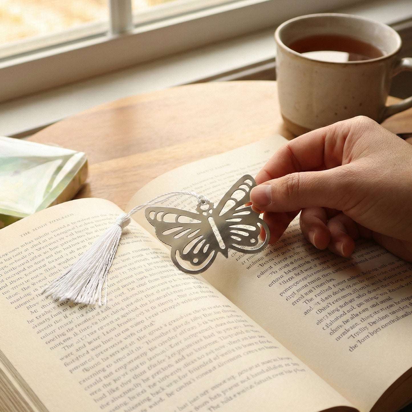 Elegant butterfly design metal bookmark by Wukusy featuring intricate butterfly details and a sleek metallic finish.