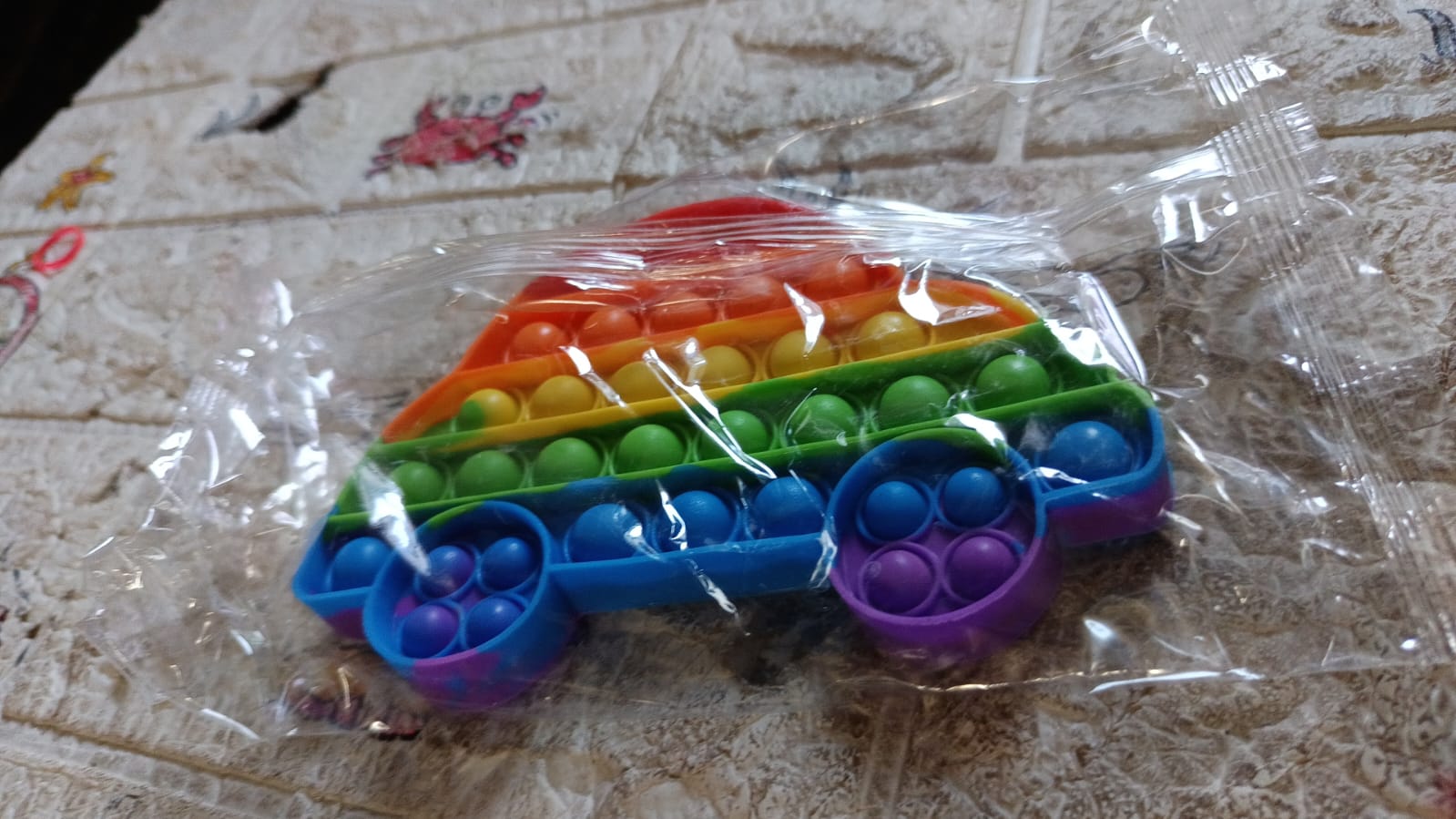 Wukusy butterfly and car shape pop fidget toy with colorful bubbles for stress relief and sensory play for kids and adults.