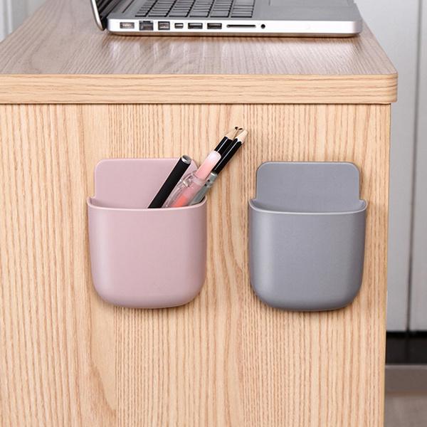 Wukusy 1487 wall-mounted storage case with mobile phone charging holder, compact mobile accessories organizer on a wall.