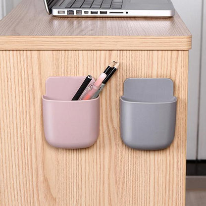 Wukusy 1487 wall-mounted storage case with mobile phone charging holder, compact mobile accessories organizer on a wall.