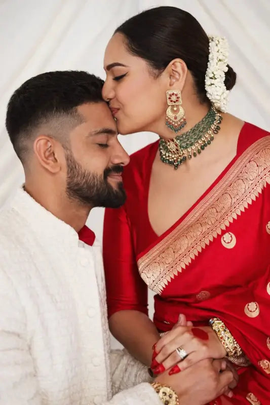 Elegant women’s silk saree from Ekom's Royal Red Banarasi Elegance Collection with intricate gold zari detailing.