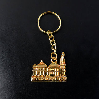Golden metal Ram Mandir keychain with intricate design, featuring the Wukusy brand logo on a small, detailed religious keychain.