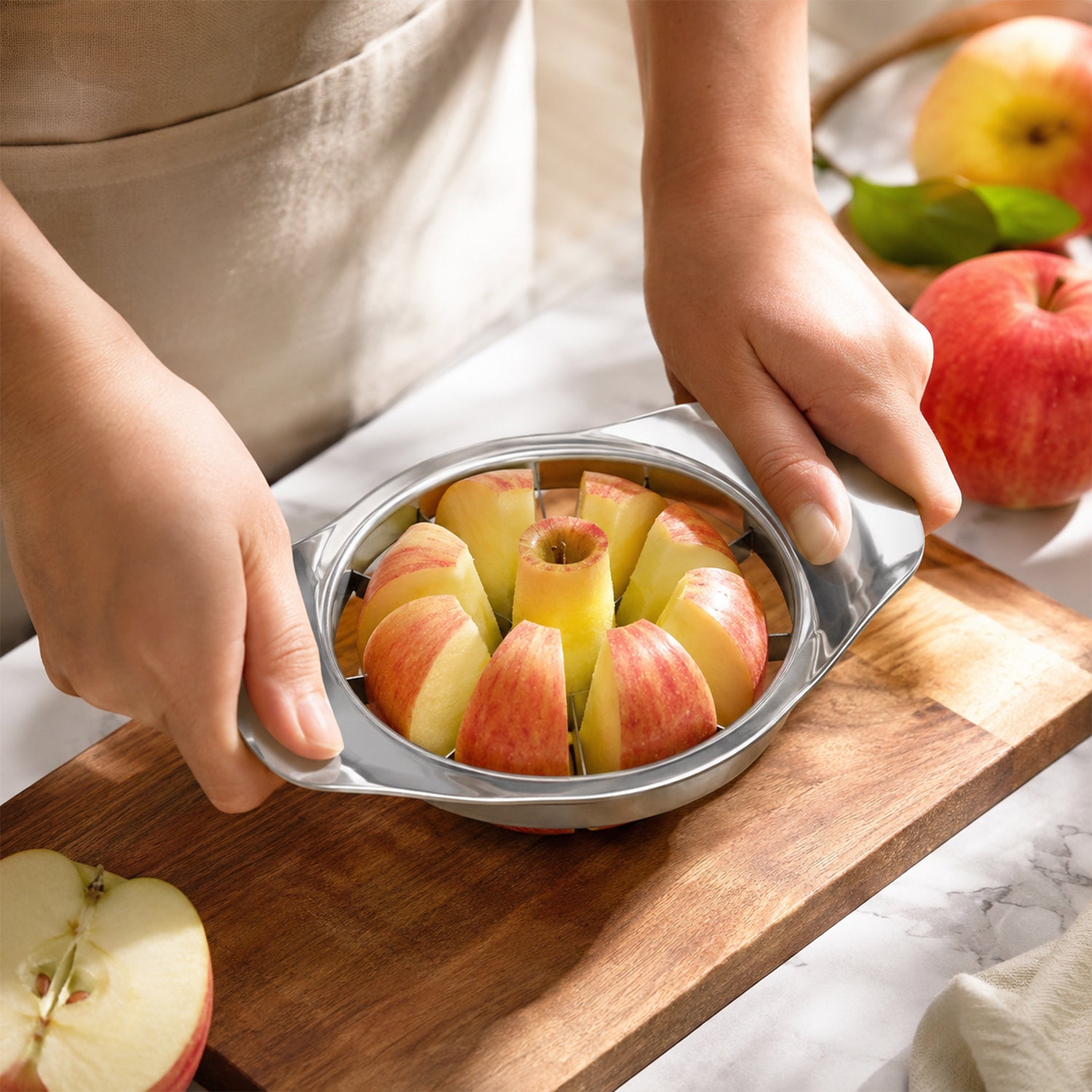 Wukusy apple-shaped stainless steel apple cutter and corer for kitchen, showing the fruit slicer with apple slices.