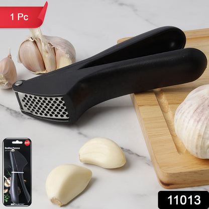 Wukusy manual garlic press crusher tool with stainless steel handle and chamber for easy garlic mincing and crushing.