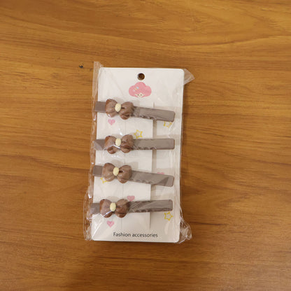 Set of four Wukusy decorative hair clips with elegant bow designs, perfect for adding a stylish touch to hairstyles.
