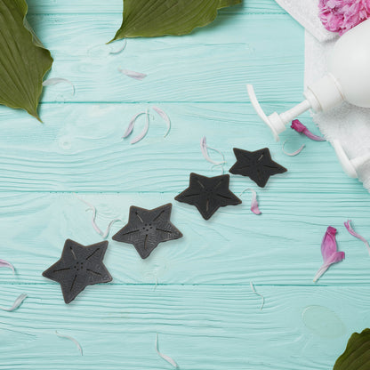 Set of four Wukusy star and leaf-shaped mini PVC anti-slip baby bath mats with textured surfaces for safety in the shower.