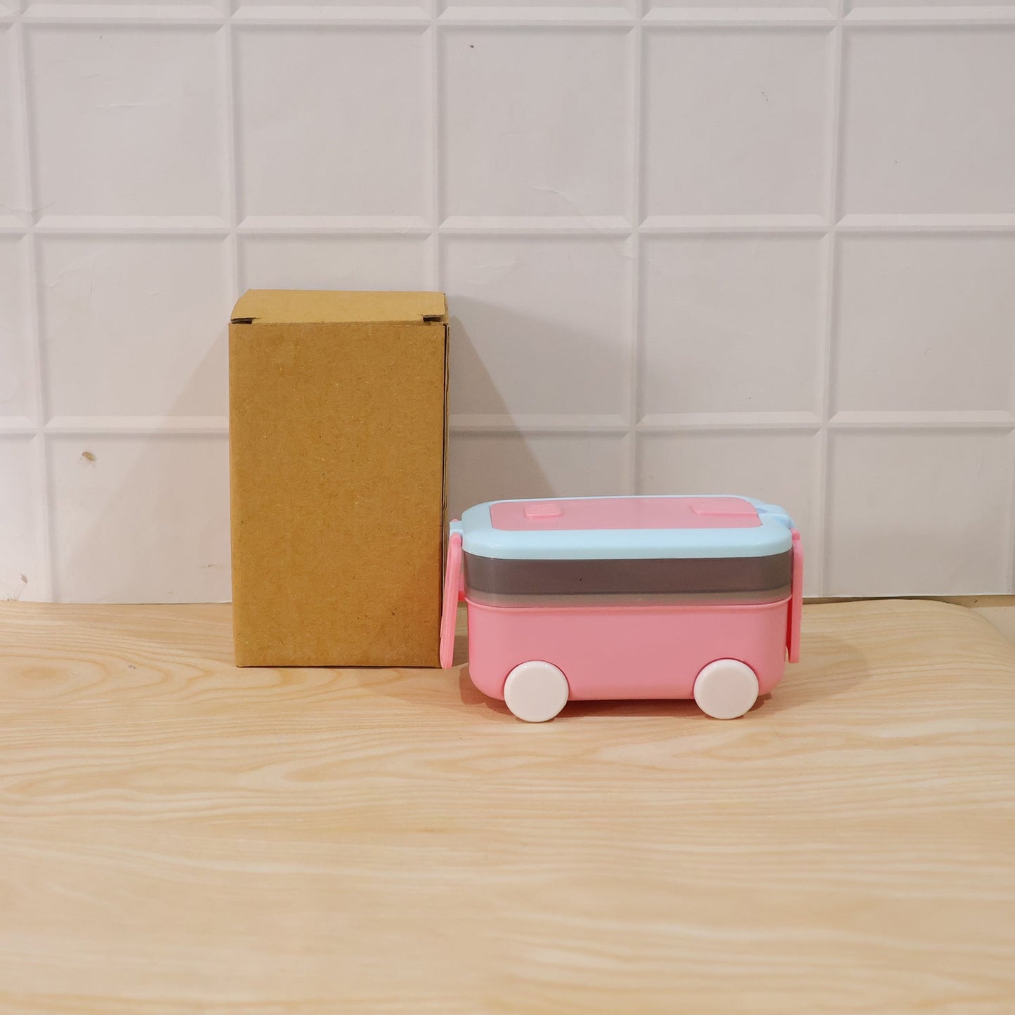 Car-shaped kids lunch box with wheels, spoon, and fork set by Wukusy, ideal for school tiffins and lunchtime.