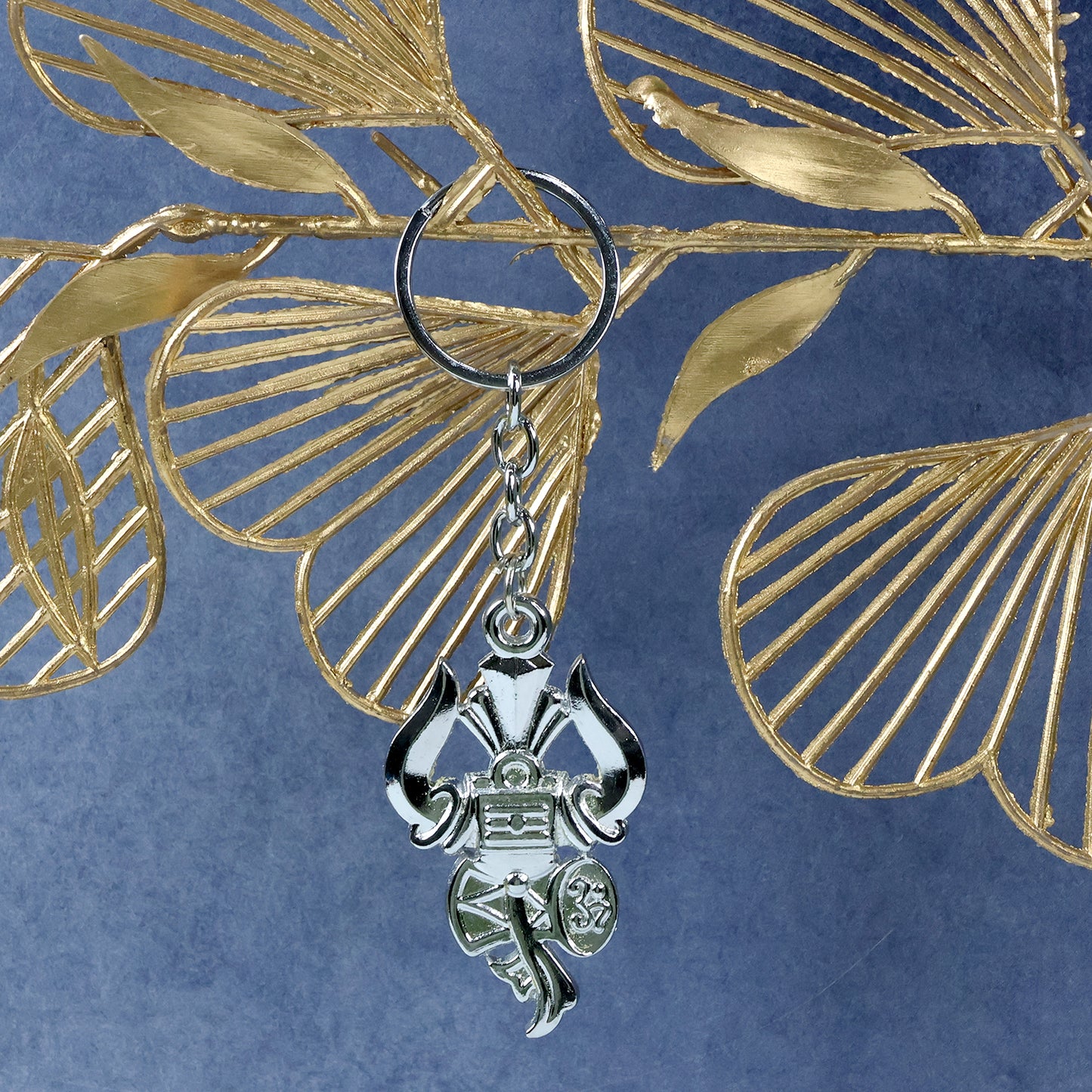 Silver keychain featuring Trishul, Damru, and Shiv symbol from Wukusy, crafted in detailed metallic design.