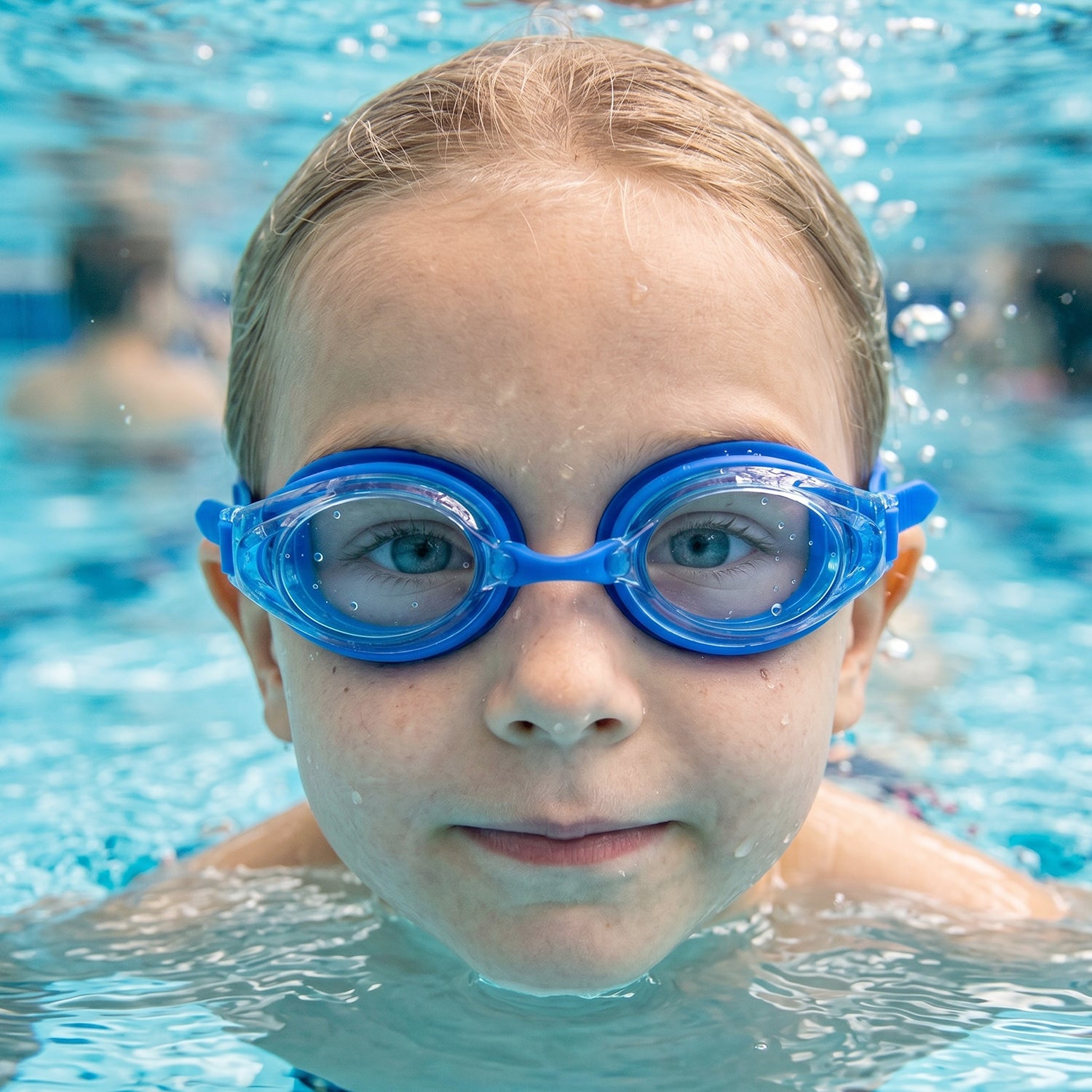 Kids' swimming goggles by Wukusy with soft cushion seal and adjustable head strap, designed for comfort and fit during swimming.