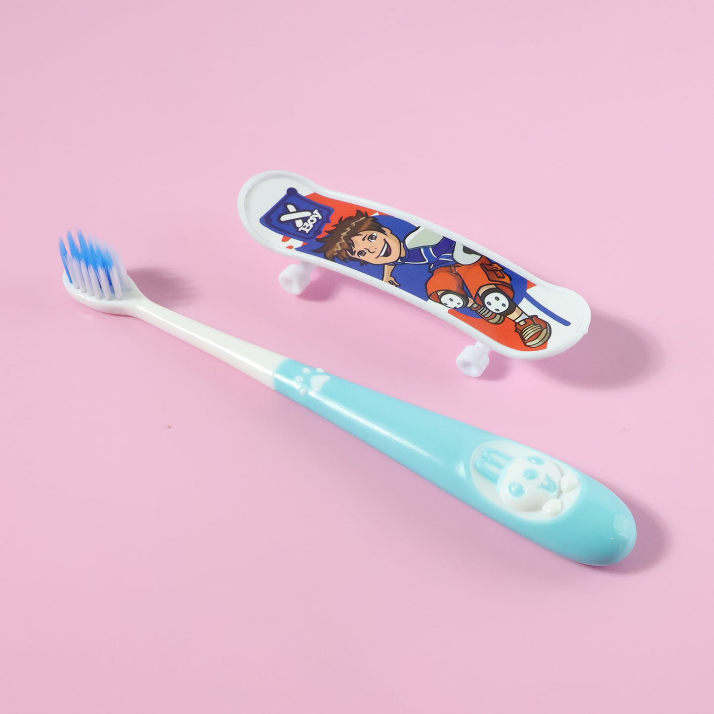 Kids Wukusy toothbrush with cartoon sketchboard toy, featuring colorful design and playful character illustrations.