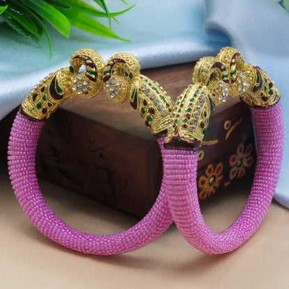 Traditional peacock design pearl bangles for women featuring intricate craftsmanship and elegant white pearls, by Ekom.