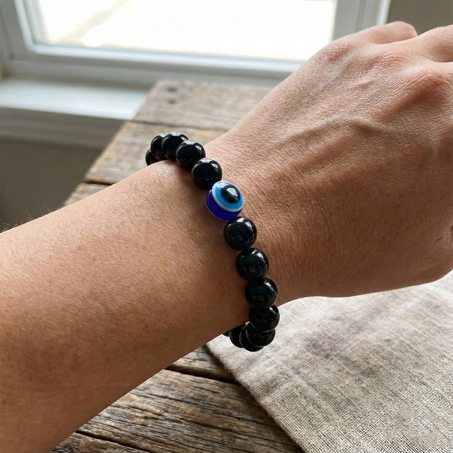 Elegant dual-tone crystal beaded stretch bracelet by Wukusy, featuring sparkling beads on a flexible band.