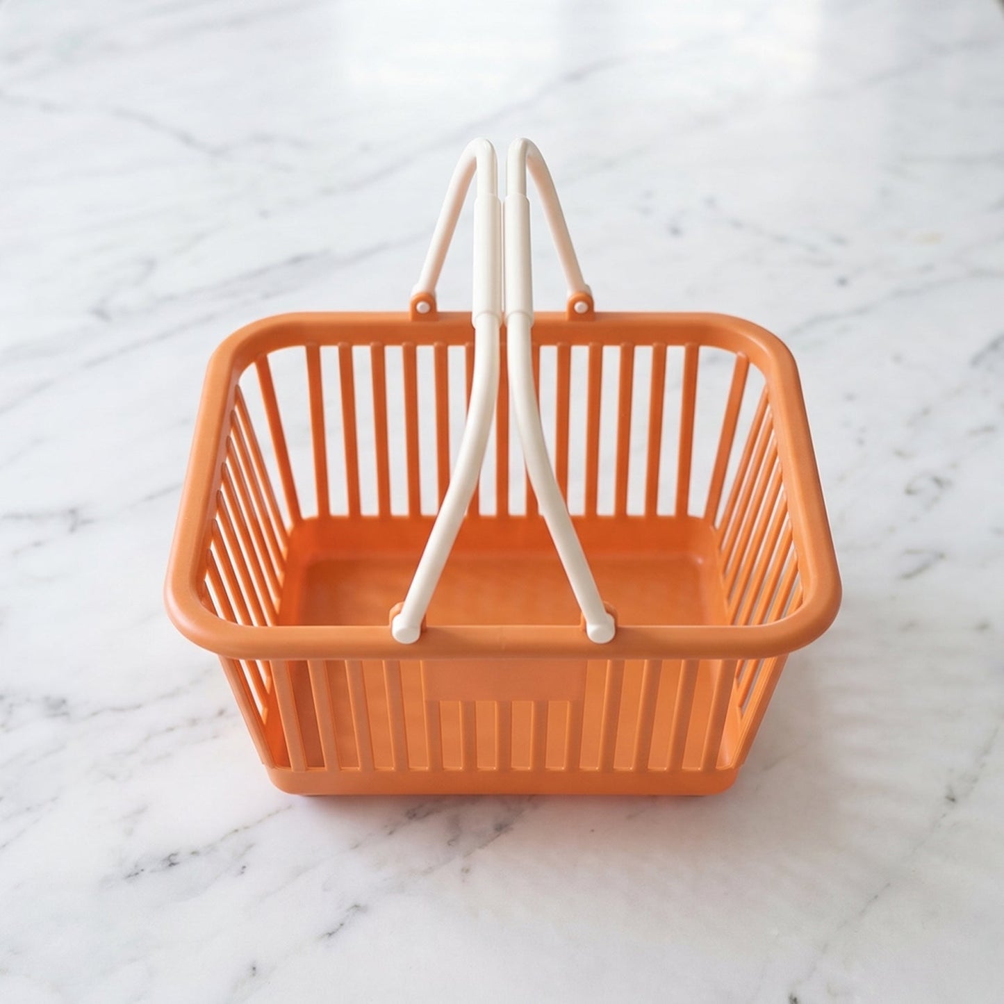 Wukusy plastic storage basket with foldable handles for fruits, vegetables, and groceries, shown in a clear image.