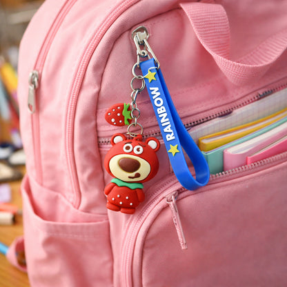 Cute teddy bear keychain with rainbow strap from Wukusy, featuring a plush teddy bear attached to a colorful rainbow strap.