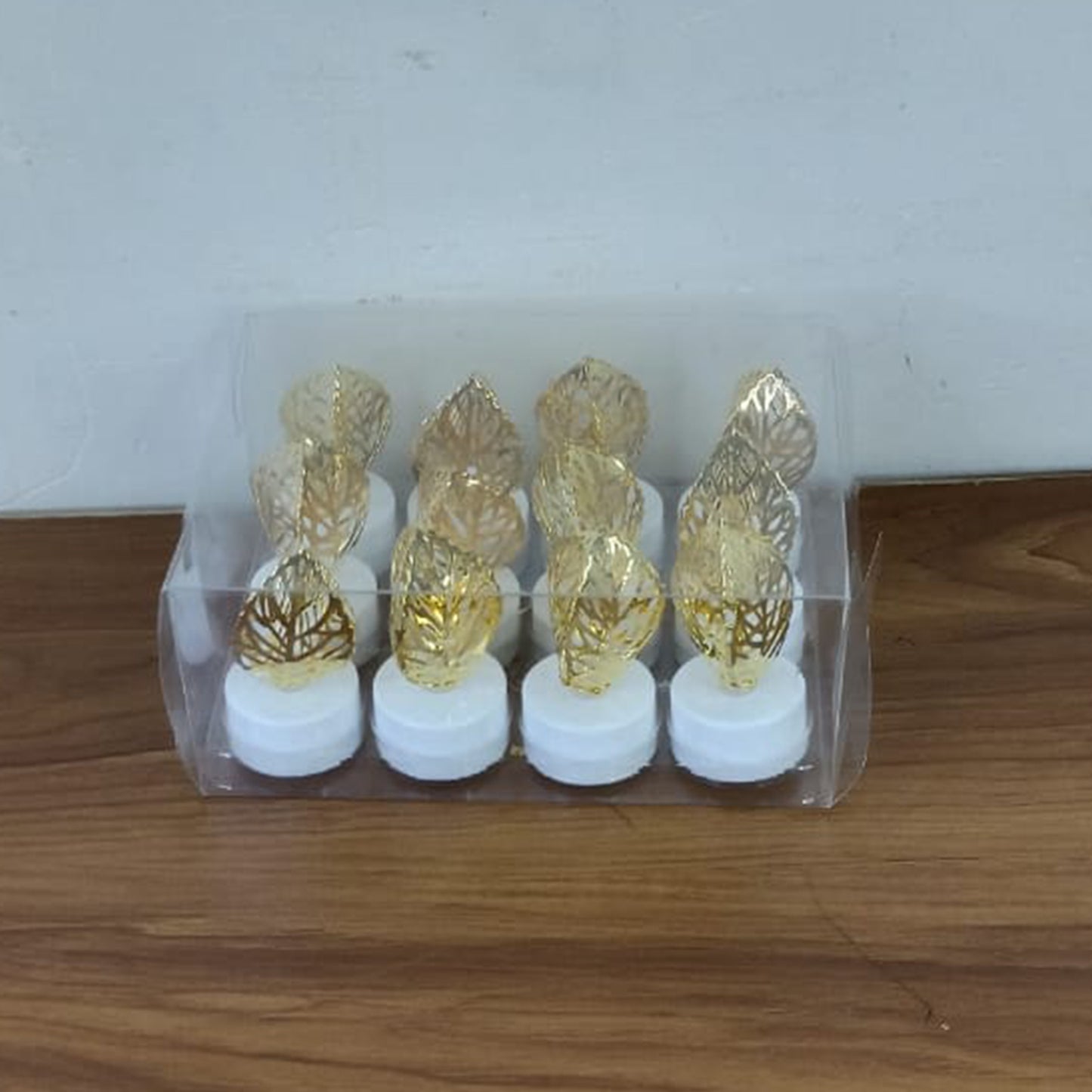 Set of 12 Wukusy decorative golden leaf-shaped flameless LED candles for elegant home decor.