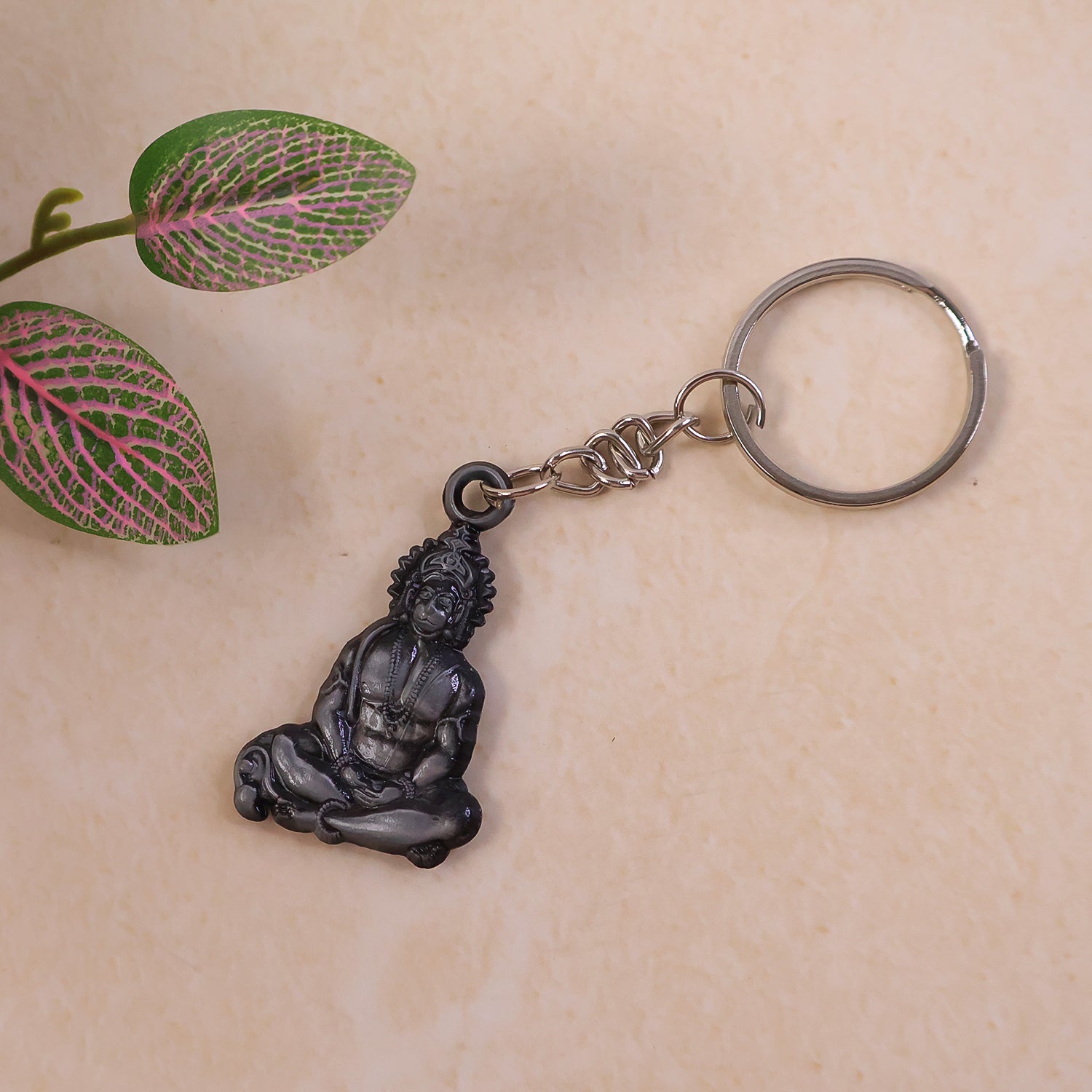 Metal keychain featuring Hanuman Ji in sitting pose, spiritual accessories by Wukusy, detailed religious figure charm.
