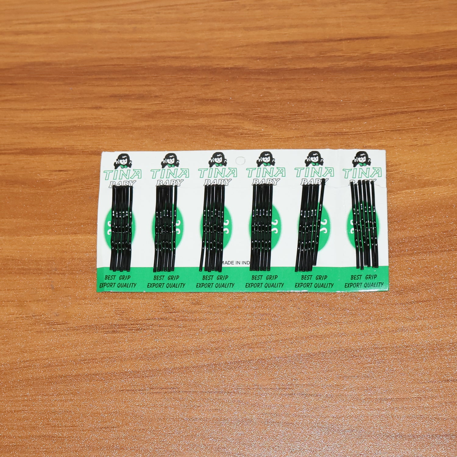 Set of 36 small black Wukusy hair bobby pins arranged on a white background for hair styling and securing.