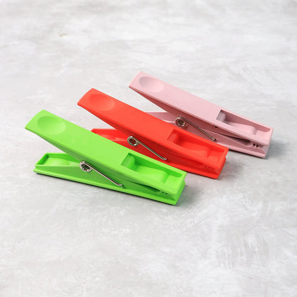 Set of 12 Wukusy durable plastic cloth clips with stainless steel springs, strong grip laundry pegs for home improvement.