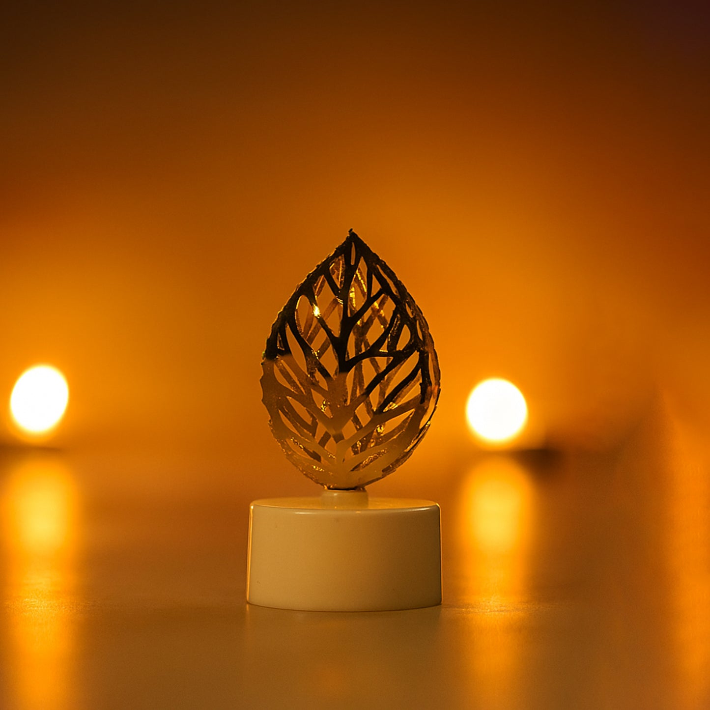 Set of 12 golden leaf-shaped flameless LED candles for home decor by Wukusy, featuring intricate leaf designs and warm LED lighting.