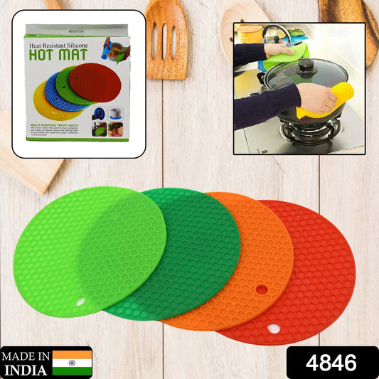 Wukusy 4-piece silicone hot mat set for protecting surfaces from hot vessels and utensils, flexible and heat-resistant.