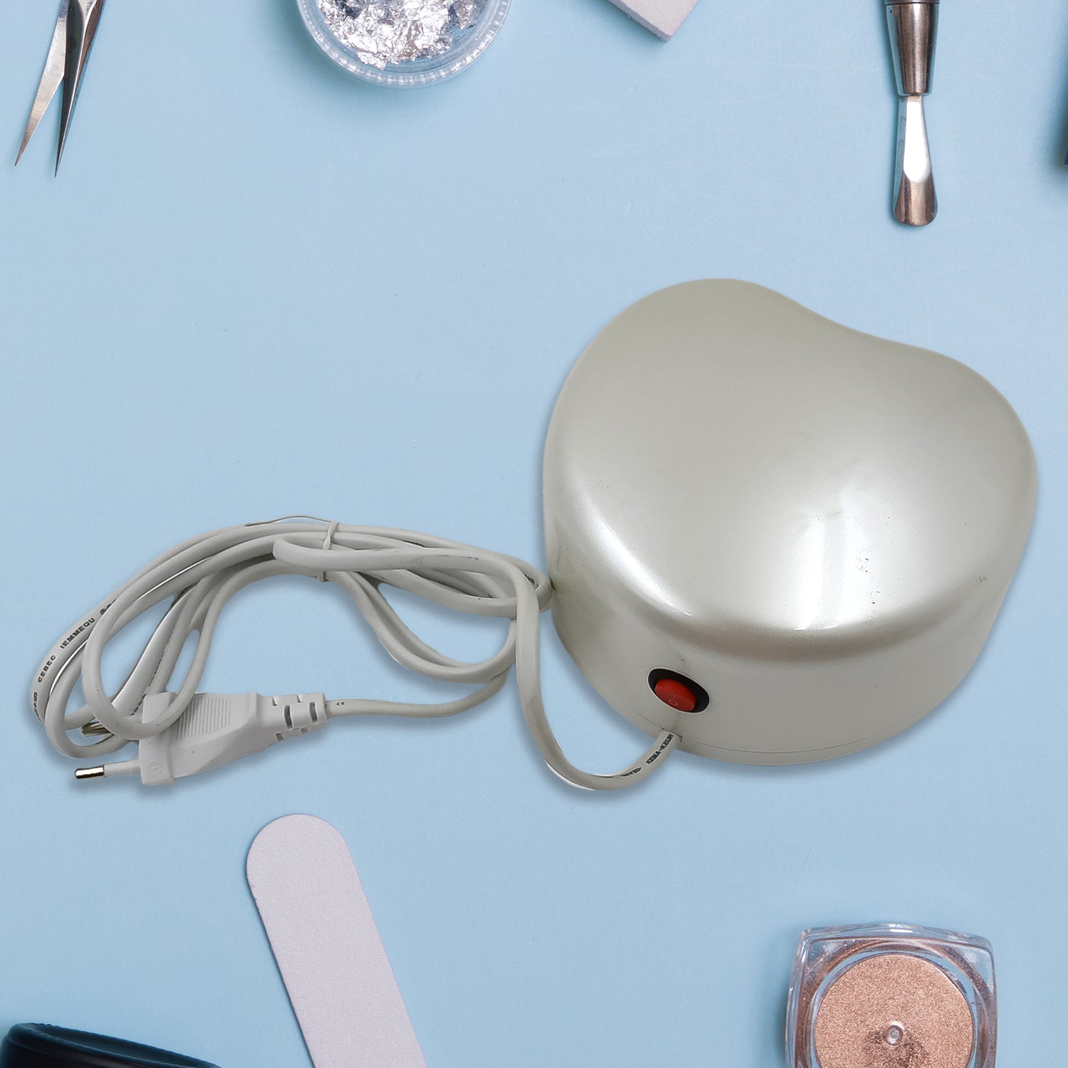 Wukusy LED UV nail dryer gel curing lamp on a white surface, showcasing its compact design for quick nail curing.