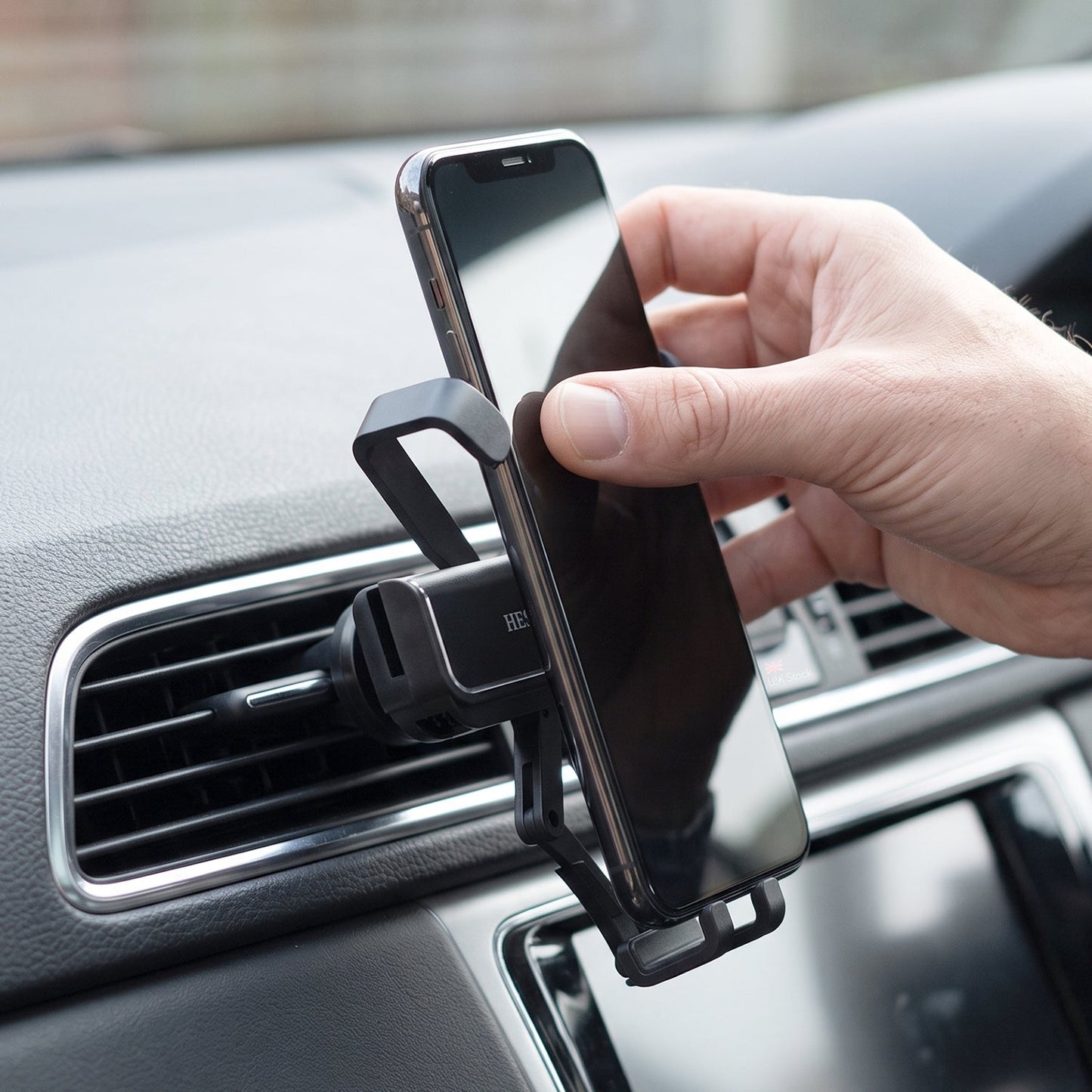 Wukusy plastic car mobile phone holder with air vent mount, 360-degree rotation, showing the mount attached to a car air vent.